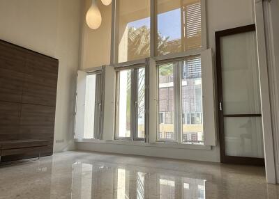 Living room with tall windows and modern lighting