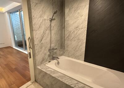 Modern bathroom with marble tiles and bathtub