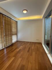 Living room with wooden floor and window with blinds