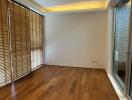 Living room with wooden floor and window with blinds