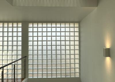 Modern staircase hallway with glass brick wall