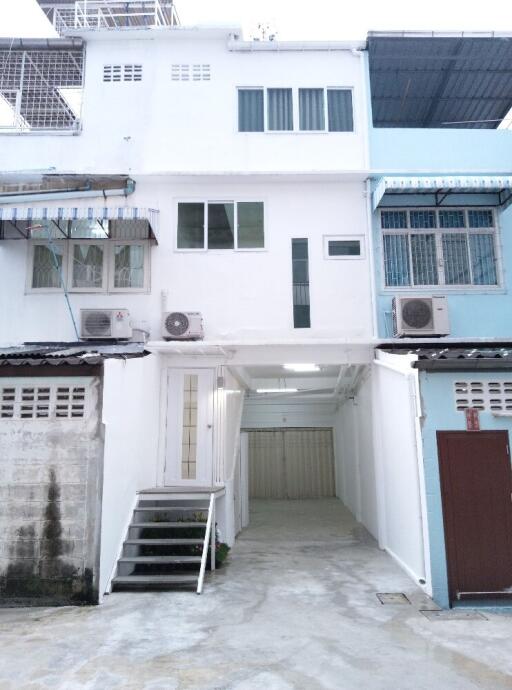 Front view of a residential building with three air conditioning units