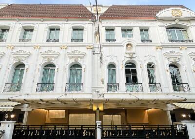 Three-story white building exterior