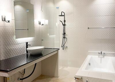 Modern bathroom with bathtub, shower and vanity