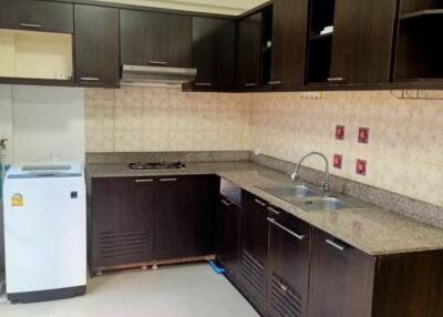 Modern kitchen with dark cabinetry and appliances