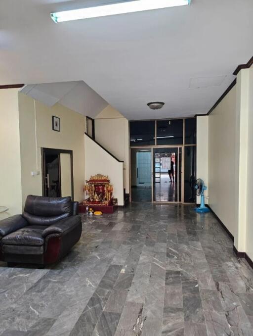 Spacious living room with marble flooring and a seating area