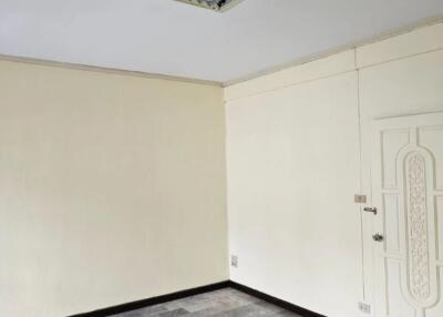 Empty room with tiled floor and white walls