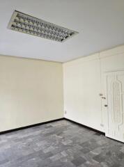 Empty room with tiled floor and white walls