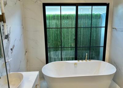 Modern bathroom with soaking tub and large window