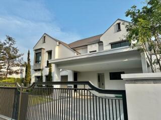 Front view of a modern two-story house with gated driveway