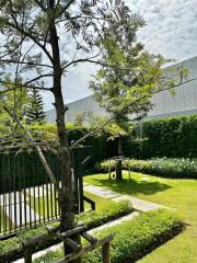 Well-maintained garden with trees and green lawn