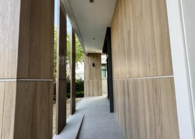 Modern exterior hallway with wooden paneling