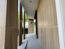 Modern exterior hallway with wooden paneling