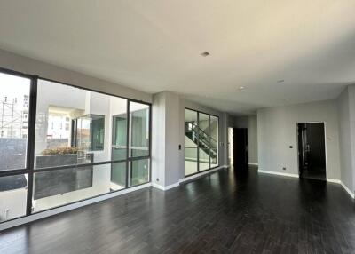 Modern living area with large windows and dark hardwood floors