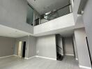 Spacious, modern living space with high ceiling and mezzanine