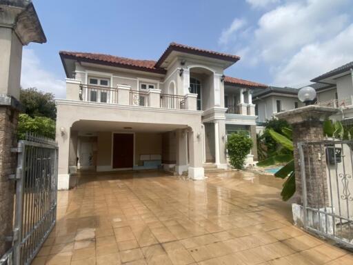 Large two-story house with garage and covered driveway