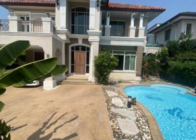 Front view of a two-story house with a pool