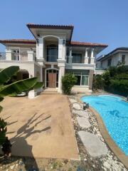 Front view of a two-story house with a pool