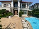 Front view of a two-story house with a pool