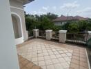 Balcony with tiled floor and view of neighborhood