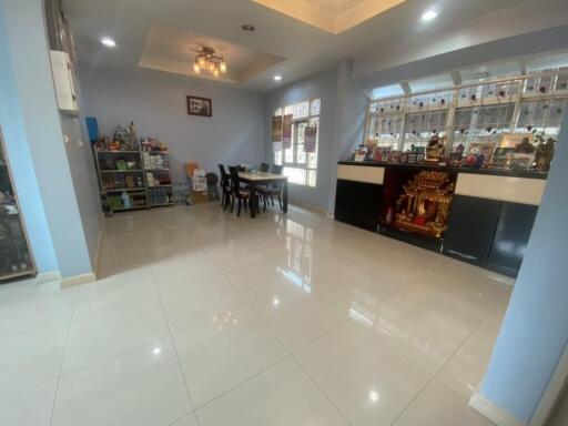 Spacious and well-lit dining area with modern furniture and ample storage