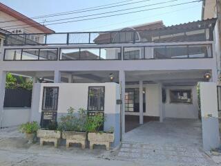 Front view of a residential house with a spacious covered parking area