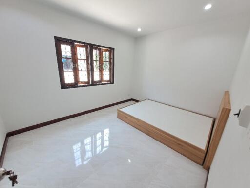 Spacious bedroom with large window