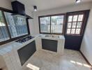 Modern kitchen with large windows and tiled countertops