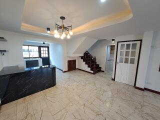 Modern living room with staircase and marble flooring