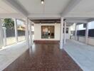 Covered outdoor space with tiled flooring