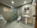 Modern bathroom with glass-enclosed shower and wall-mounted sink