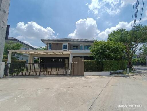 Exterior view of a modern two-story house with a driveway and garage