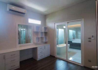Modern bedroom with dressing table and large sliding door