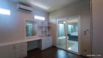 Modern bedroom with dressing table and large sliding door