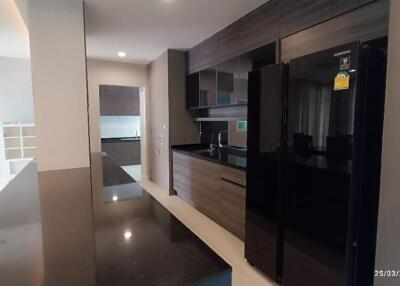 Modern kitchen with sleek black refrigerator and built-in cabinets