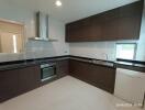 Modern kitchen with dark wood cabinets and a large window