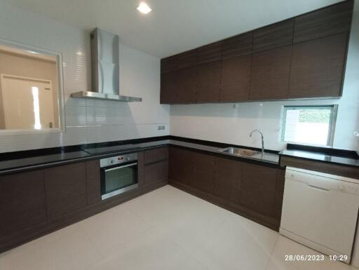 Modern kitchen with dark wood cabinets and a large window