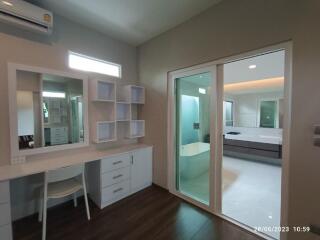 Modern bedroom with vanity and attached bathroom