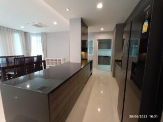 Modern kitchen with island and dining area in view