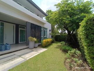 Front view of a modern house with garden