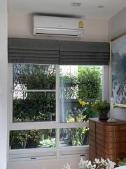 Living room with large window and air conditioner