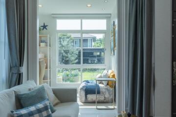 Bright and cozy living area with large window view