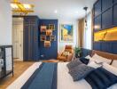 Contemporary bedroom with vibrant blue accents and cozy seating area