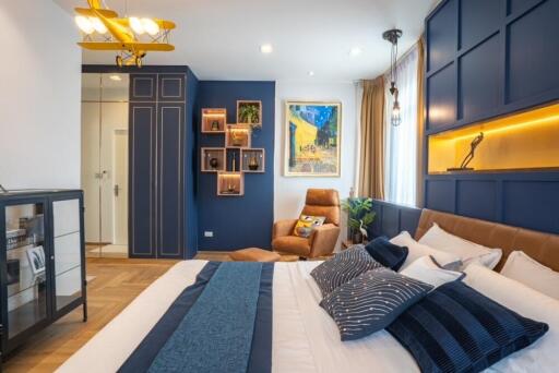 Contemporary bedroom with vibrant blue accents and cozy seating area