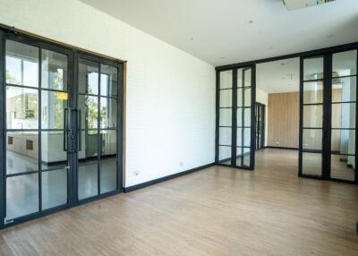 Modern living area with glass doors and hardwood floors