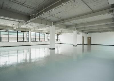 Spacious empty room with large windows and polished floor