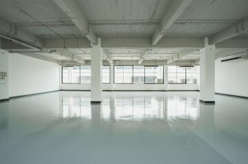 Spacious industrial-style commercial area with large windows