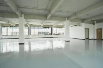 Spacious empty room with large windows and polished floor