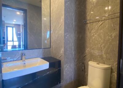 Modern bathroom with marble walls and a large mirror