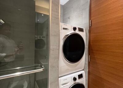 Modern laundry room with stacked washer and dryer